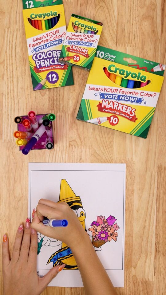 Child coloring with Crayola markers and colored pencils